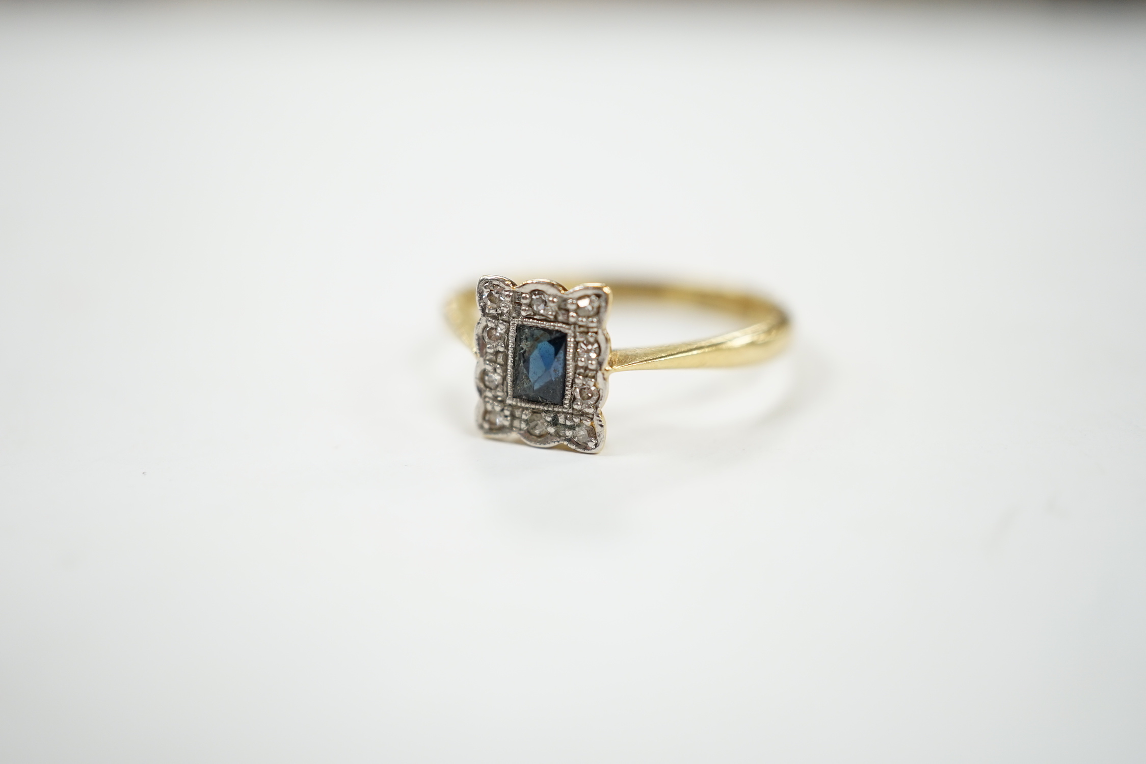 A 1920's 18ct and plat, sapphire and diamond set rectangular cluster ring, size M, gross weight 2.8 grams.